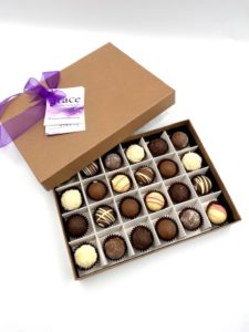 Grace Chocolates Changing Lives Special Edition Box of 24 truffles in a recycled box on a white backdrop