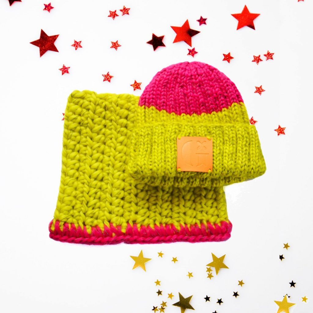 A kids beanie and snood set shown on a white background with red stars