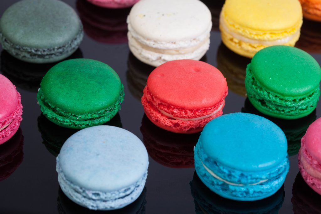 Multi-coloured macaroons on a black table