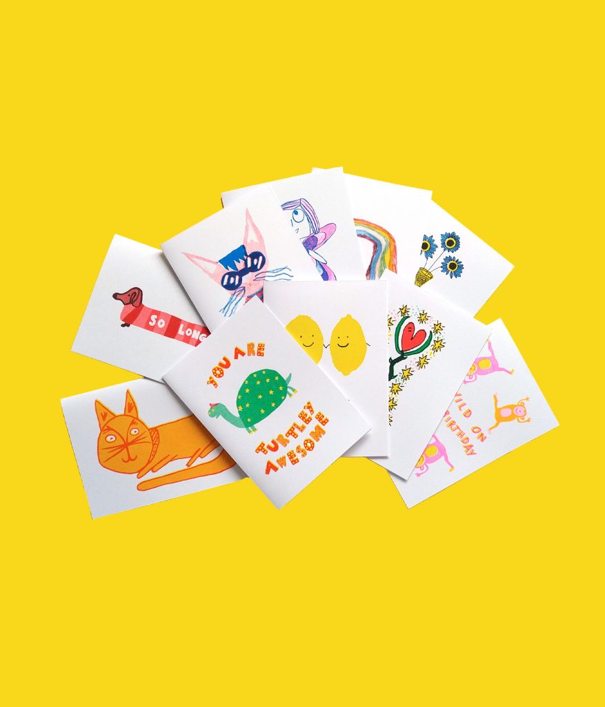 10 greetings cards all laid out on a yellow background, each one has illustrations with animals or flowers