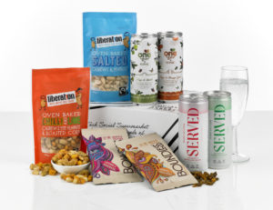 A gift box with food and drink contents shown around it.