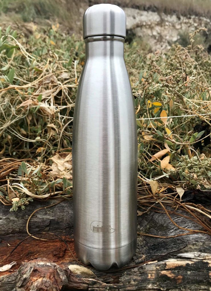 A stainless steel bottle in a outdoors area