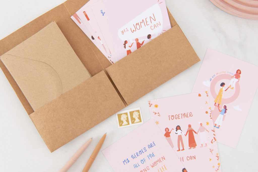 Light pink cards displaying illustrations with assorted messages throughout the set which celebrate women and their incredible ability to achieve great things when they support one another.