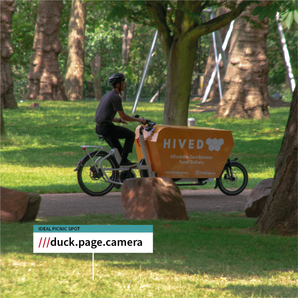 A man rides a Hived delivery bike. There's a what3words location call-out over the image showing a location in Finsbury Park