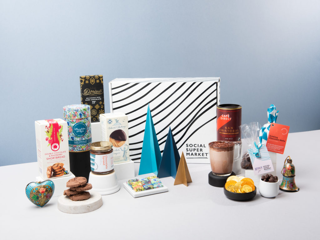 A display of the products in the Chocolate Lover Gift Box, including a range of chocolate snacks and drinks, surrounded in festive decorations.