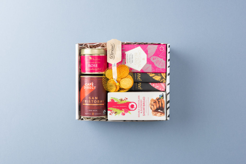 A Social Supermarket Gift box containing Divine Chocolate bars, Hot Chocolate by Cafedirect, Divine Chocolate coins and Original Beans Piura chocolate bar.