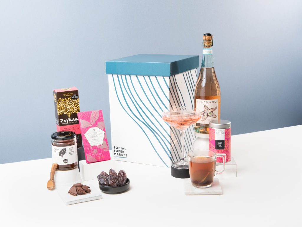 A display of The Pink Fizz Gift Box, including snacks, tea, and prosecco rosé.