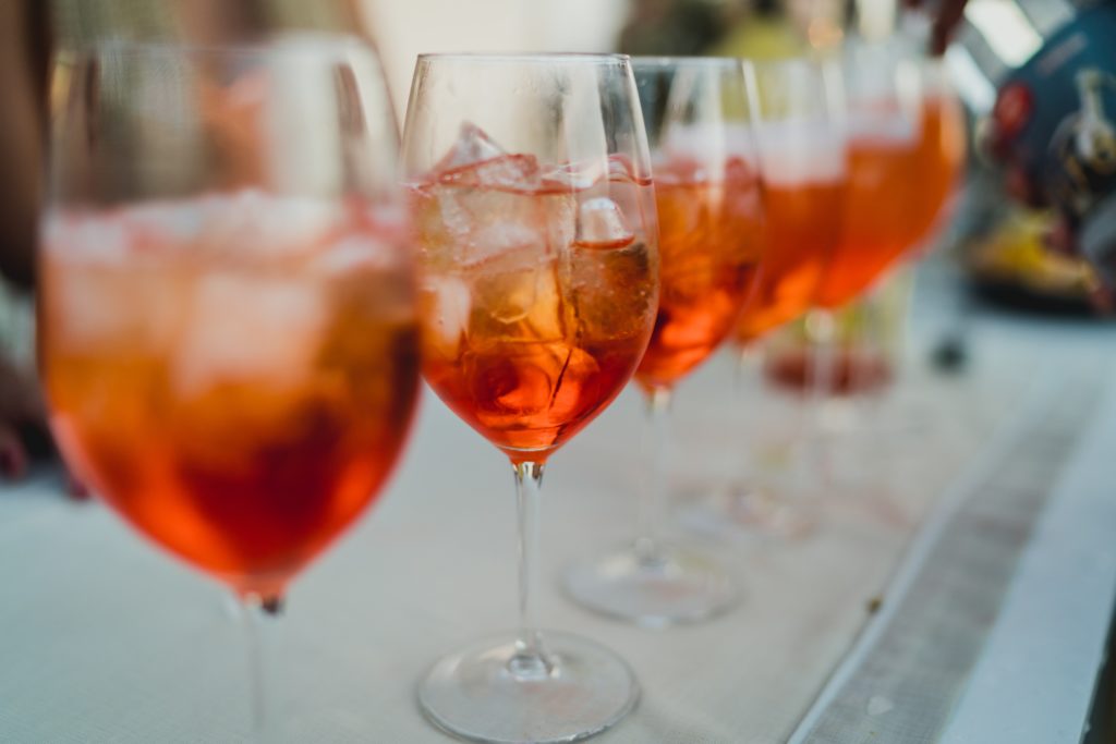 A row of Aperol spritz style cocktails