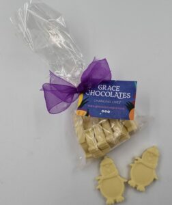 White chocolate penguins in their packaging and two out of the pack