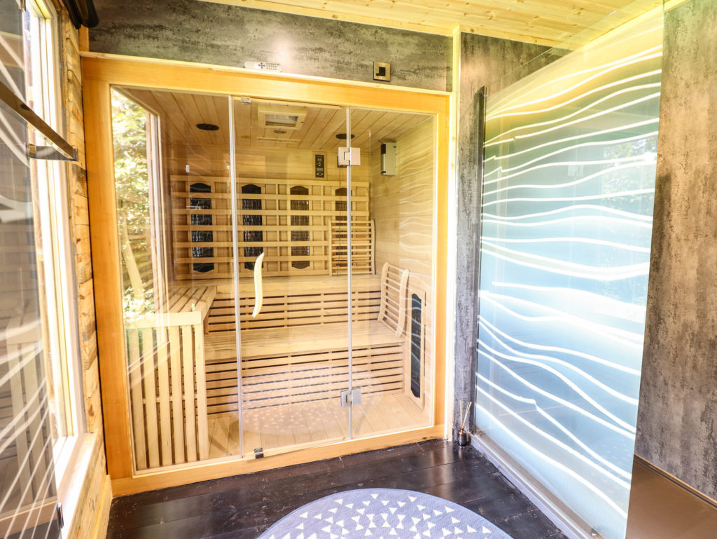 A sauna with a glass door
