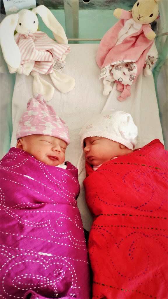 Opi and Mahi, founder Laura's children hours after they were born wrapped in Khushi Kantha blankets 