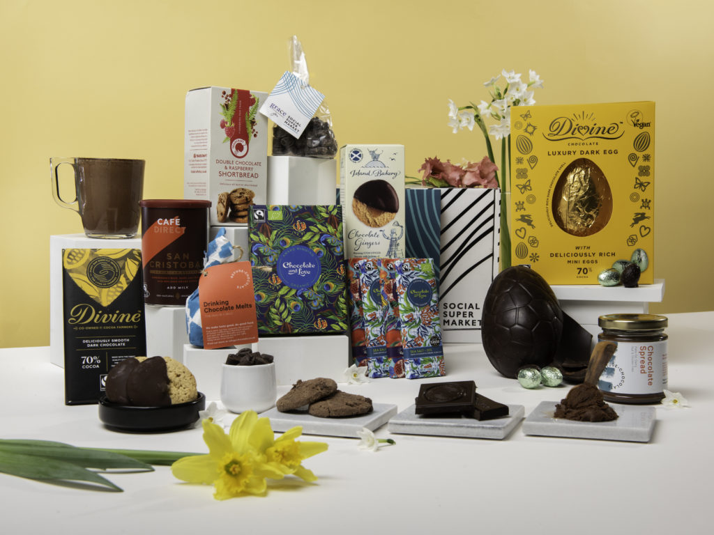The Easter Chocolate Lover Gift Box, showing its contents surrounding the gift box they come in, including a Divine Chocolate Easter egg
